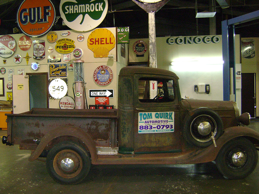 Vintage Tom Quirk Automotive pickup truck inside the shop